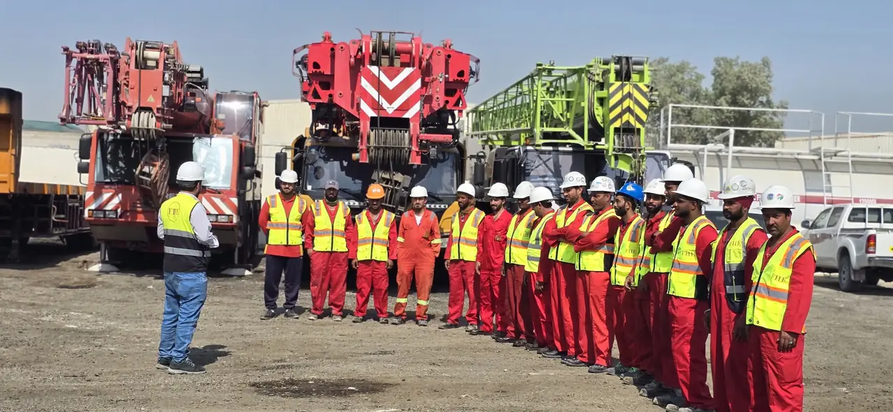 A briefing to a line of FHS crew in front of the parked mobile cranes