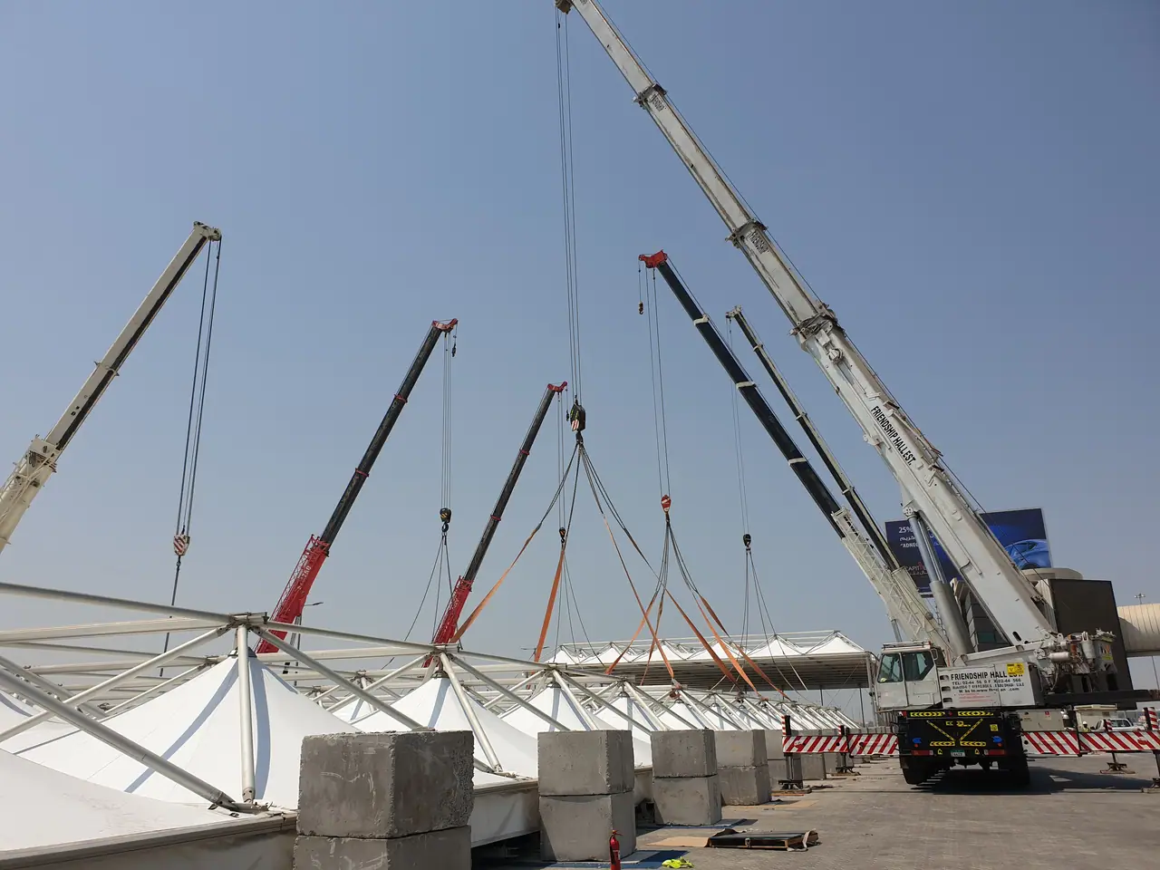 Four mobile cranes in a coordinated multi-crane lift of a tensile fabric roof